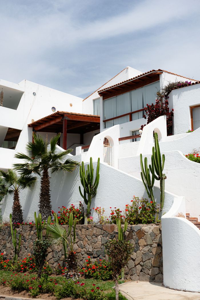 gallery-5 Contemporary villa exterior with cacti and palm trees, ideal for luxury living.