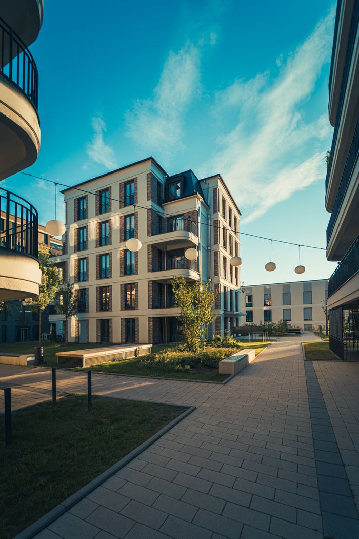 services-03 Modern apartment complex under clear blue skies, showcasing contemporary architecture and urban living.